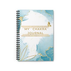 May include: A blue and gold spiral bound journal with the text "My Chakra Journal" and a gold butterfly on the cover.