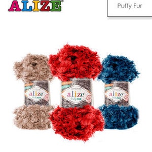 May include: Three skeins of yarn in beige, red, and blue. The yarn is fluffy and has a fuzzy texture. The yarn is labeled "Alize Puffy Fur".