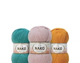 May include: Three balls of yarn in teal, pink, and yellow. Each ball has a white label with the text "NAKO Super Inci" printed on it.