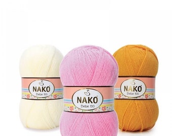 May include: Three balls of yarn in yellow, pink, and orange. Each ball has a label that reads "Nako Bebe 100".