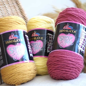 May include: Three skeins of yarn in yellow, light yellow, and burgundy. The yarn is labeled "Himalaya Super Soft Yarn".