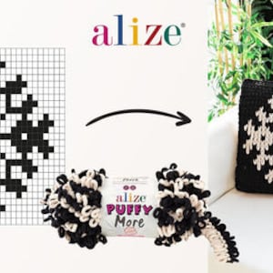 May include: A black and white snowflake pattern is shown on a graph paper grid. The pattern is also shown on a knitted pillow. The yarn used to knit the pillow is shown in a ball, with the brand name "Alize Puffy More" on the label.