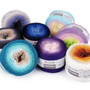 May include: Assortment of eight gradient yarn skeins in various colors, including blue, purple, pink, orange, and green. Each skein features a label with the text "YarnArt RoseGarden".