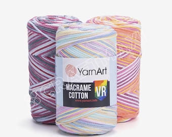 May include: Three spools of colorful yarn for macrame projects. The yarn is a mix of white and pastel colors, including pink, blue, yellow, and orange. The label reads "YarnArt Macrame Cotton VR www.yarnart.info"
