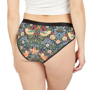 May include: Black and blue underwear with a floral print featuring birds and leaves. The print is inspired by William Morris's designs.