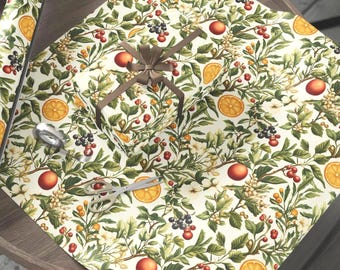 May include: Vintage botanical gift wrap featuring a repeating pattern of oranges, berries, and foliage in shades of green, orange, and cream. A wrapped gift with a brown ribbon and scissors are on the paper. The text "3 SIZE ROLLS" is visible.