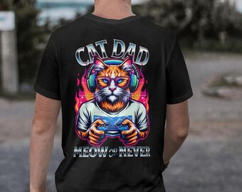May include: Black t-shirt featuring a graphic of a cat wearing headphones and holding a video game controller. The text "Cat Dad Meow or Never" is printed below the cat.