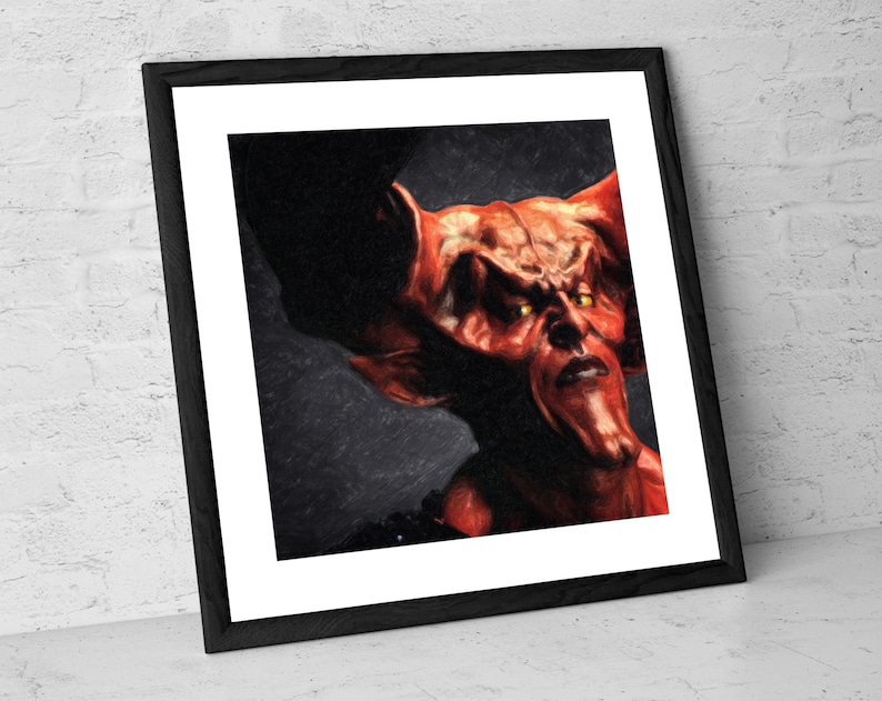 May include: A close-up portrait of a red demon with horns and yellow eyes. The demon has a serious expression and is looking directly at the viewer. The background is dark and blurry.