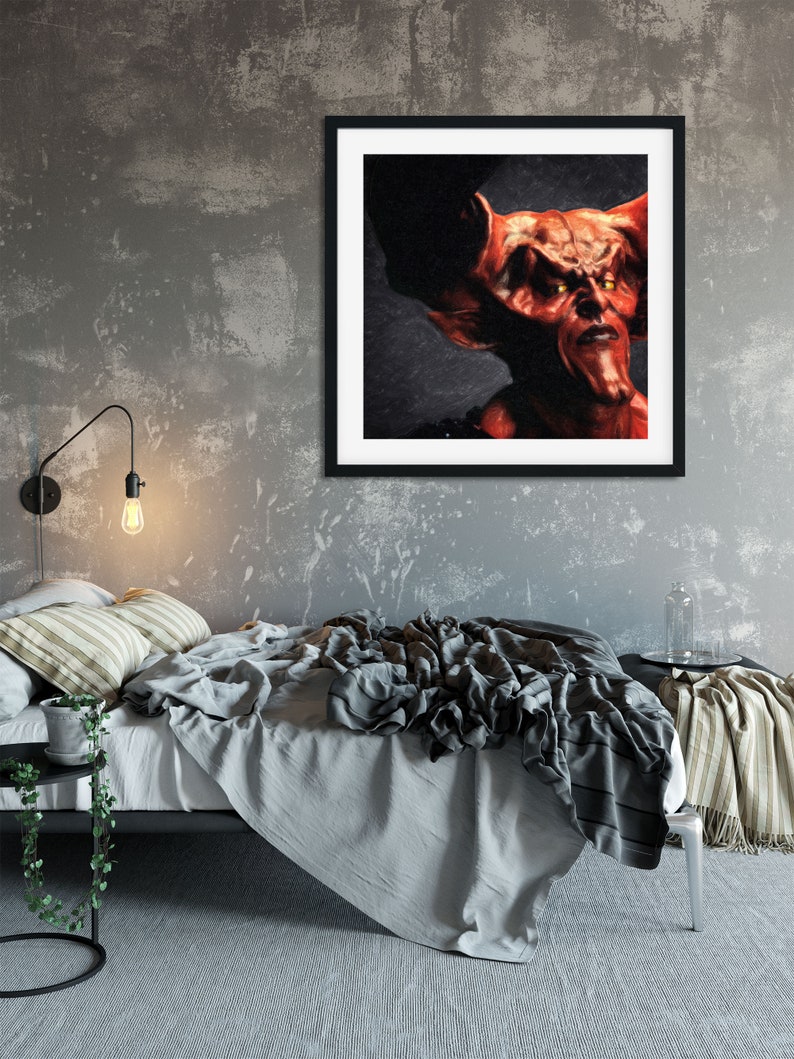 May include: A framed painting of a red demon with horns and glowing yellow eyes. The demon is looking directly at the viewer with a serious expression.