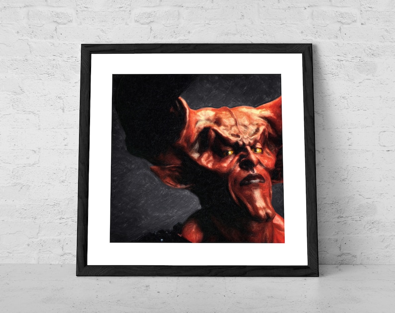 May include: A close-up of a red demon with horns and yellow eyes. The demon is looking directly at the viewer with a serious expression. The background is dark and blurry.