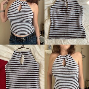 May include: A halter top with horizontal stripes in light blue and dark brown. The top has a keyhole detail at the neckline and a tie closure. The top is made of a knitted material.