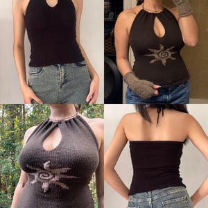 May include: A collection of halter tops in various shades of brown and black. The tops feature a keyhole design at the neckline. One top has a sunburst design. The tops are paired with blue jeans. The tops are made of a knitted material.