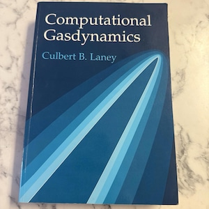 May include: A hardcover book titled "Computational Gasdynamics" by Culbert B. Laney. The cover is a deep blue with a gradient design of light blue and white curved lines. The title is in white, sans-serif font.