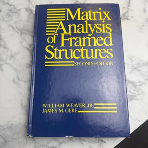 May include: A blue book titled "Matrix Analysis of Framed Structures, Second Edition." The title is in yellow, with the authors' names, William Weaver Jr. and James M. Gere, at the bottom.