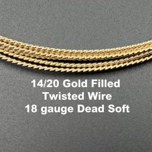 May include: Close-up of gold-filled twisted wire, 18 gauge dead soft. The image shows several strands of the wire, with the text "14/20 Gold Filled Twisted Wire 18 gauge Dead Soft" in white.