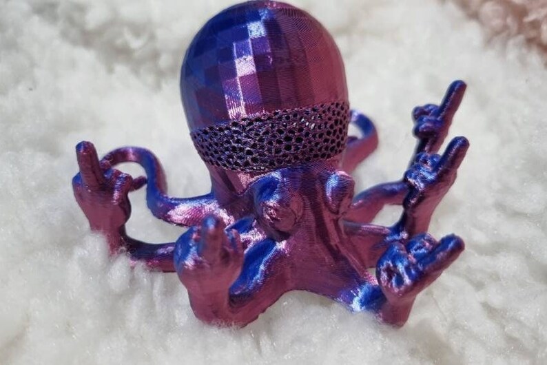 May include: A 3D printed octopus figurine with a blue and purple iridescent finish. The octopus has eight tentacles, each with a hand at the end, making a rock and roll hand gesture.