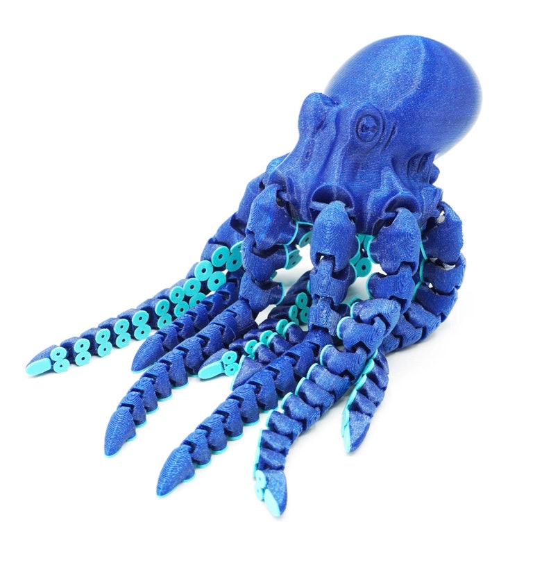 May include: A blue octopus toy with segmented arms and light blue accents. The octopus is made of plastic and has a textured surface.