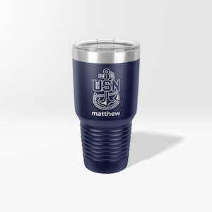 May include: A navy blue stainless steel tumbler with a white anchor and the text "USN" and "matthew".