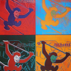 May include: A vintage toy monkey with a red, blue, yellow, and black color scheme. The monkey is swinging on a rope and the text "ОБЕЗЬЯНКА" is printed on the toy. The toy is made in the USSR.