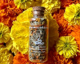 May include: A glass jar filled with dried herbs and flowers, labeled "Honoring Ancestors Incense Blend". The jar is surrounded by yellow and orange marigold flowers.