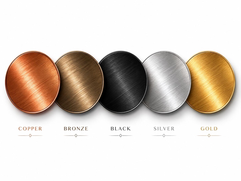 May include: Five circular metal discs arranged in a horizontal row, each featuring a distinct brushed finish. The colors from left to right are copper, bronze, black, silver, and gold. Each disc is labeled below with its corresponding color name.
