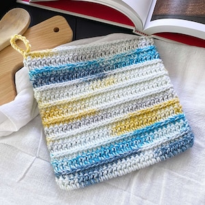 May include: A crocheted pot holder with a striped pattern in shades of blue, yellow, and white.