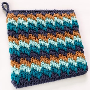 May include: A crocheted pot holder with a blue, teal, and orange striped pattern. The pot holder has a loop for hanging.