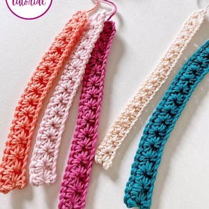 May include: Five crocheted straps in different colors: coral, pink, magenta, cream, and teal. The straps are all the same width and have a similar stitch pattern.