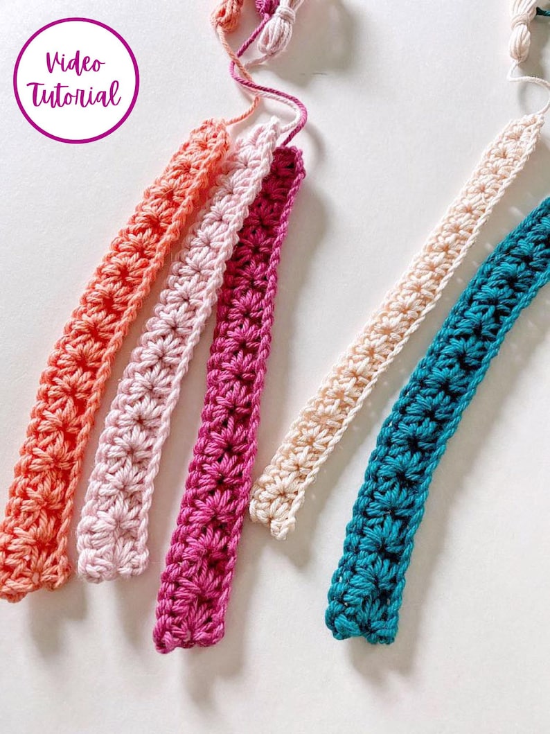 May include: Five crocheted straps in different colors: coral, pink, magenta, cream, and teal. The straps are all the same width and have a similar stitch pattern.