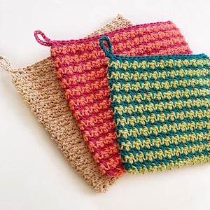 May include: Three crocheted pot holders in different colors. One is beige, one is pink and orange striped, and one is green and yellow striped.