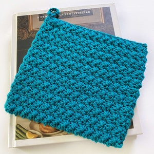 May include: A teal blue crocheted pot holder with a loop for hanging.