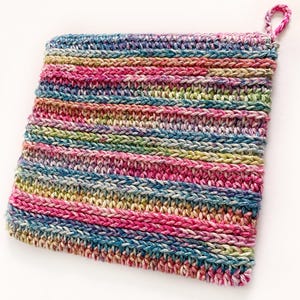 May include: A colourful striped crocheted pot holder with a loop handle. The pot holder is made with a variety of shades of pink, blue, green, and white yarn.
