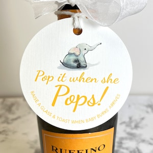 May include: A white circle tag with a yellow elephant illustration and the text 'Pop it when she Pops! Raise a glass & toast when baby Burke arrives'.
Pop It When She Pops Personalized Baby Shower Mini Champagne Bottle Favor Tag Prosecco Elephant Gift Tag Custom Baby Shower Gift Tag