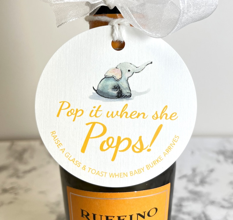 May include: A white circle tag with a yellow elephant illustration and the text 'Pop it when she Pops! Raise a glass & toast when baby Burke arrives'.
Pop It When She Pops Personalized Baby Shower Mini Champagne Bottle Favor Tag Prosecco Elephant Gift Tag Custom Baby Shower Gift Tag