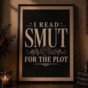May include: A framed black print with the text "I READ SMUT FOR THE PLOT". The design includes a rose graphic. The print is displayed on a wooden surface with candles and books, creating a vintage aesthetic.