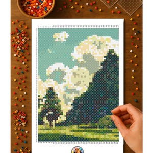 May include: A pixel art landscape scene with a forest and sky, created with colorful beads on a white sheet. The sheet is on a wooden surface, with a bowl of beads and two clear plastic templates nearby. The Two Suns logo is visible.