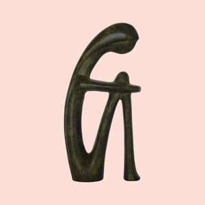 Cycladic Female Figurine - Highly stylized with only the most general and prominent body features represented - Bronze