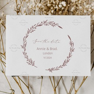 May include: Save the date card with a floral wreath design. The card says "Save the Date" with the names "Annie & Brad." and the location "London" with the date "9.7.2024".