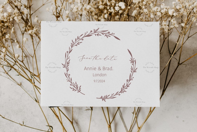 May include: Save the date card with a floral wreath design. The card says "Save the Date" with the names "Annie & Brad." and the location "London" with the date "9.7.2024".