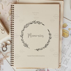 May include: A cream-coloured spiral bound journal with a black wreath design and the word "Memories" in the centre. The journal has the text "Copyright Reserved @TheWreathShop" at the bottom.