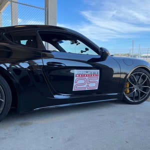 May include: Black Porsche sports car with a Pruitt Motorsport sticker and the number 25 on the side.