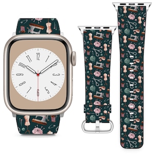 May include: A green Apple Watch band with a sewing themed pattern. The band features a repeating pattern of sewing machines, spools of thread, scissors, and pins. The band is shown on a silver Apple Watch with a white face.