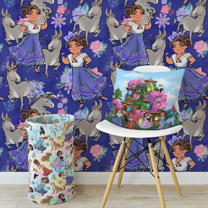 May include: A white chair with a blue and purple patterned throw pillow featuring a cartoon illustration of a house with pink flowers. The chair is in front of a wall with a repeating pattern of cartoon donkeys and girls in blue dresses.