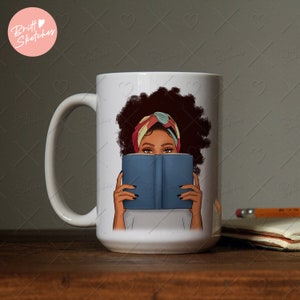 May include: White ceramic mug with a colorful illustration of a person with curly hair holding a blue book in front of their face. The person is wearing a colorful headscarf.