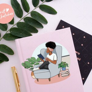 May include: A pink journal with an illustration of a person reading in a chair. The illustration includes a person with dark hair, a white shirt, and black pants. The journal has the text "two" and "ent" on the cover.
