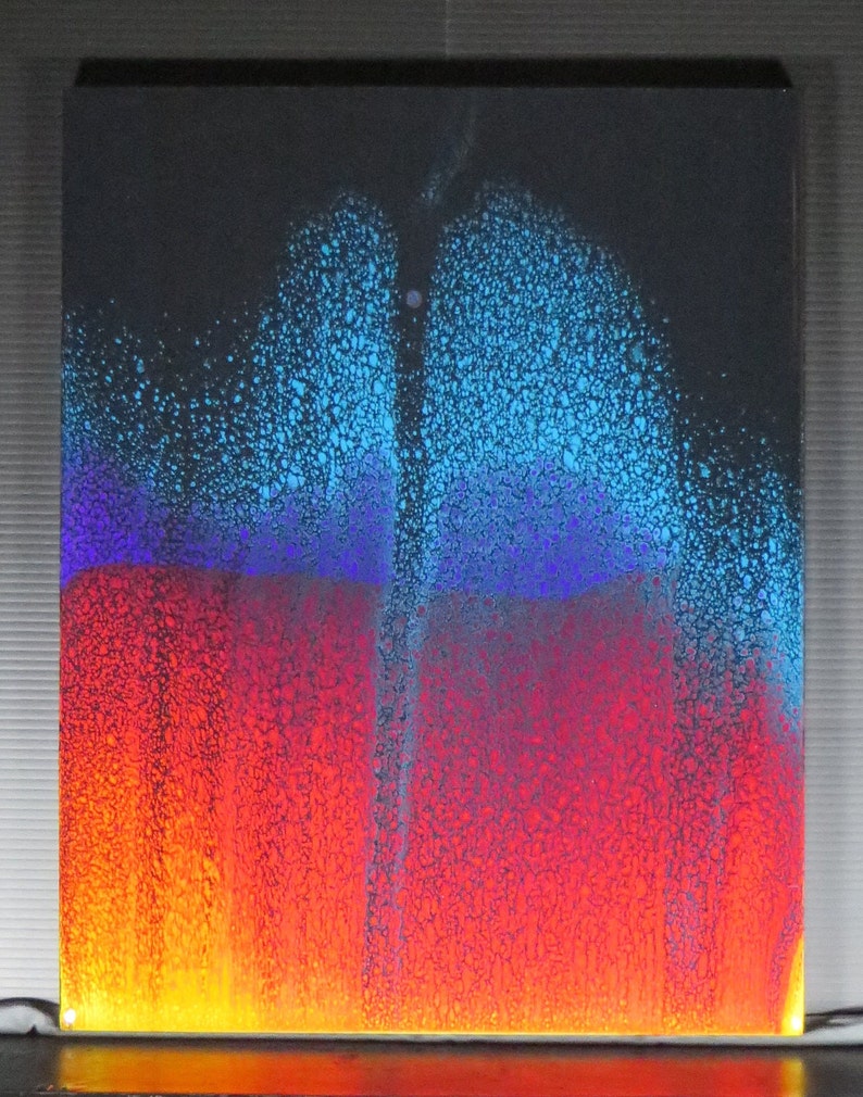 May include: Abstract art painting with a blue, purple, red, and yellow colour scheme. The paint is textured and appears to be made of small dots.
