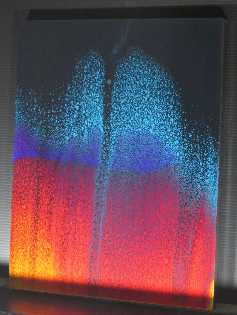 May include: Abstract painting with a blue, purple, red and orange colour scheme. The paint is applied in a splatter technique, creating a textured effect.