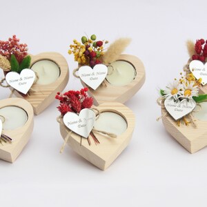 May include: Five wooden heart-shaped candle holders with a small tea light candle in each. Each holder is decorated with dried flowers and a small silver heart tag with the text "Name & Name Date".