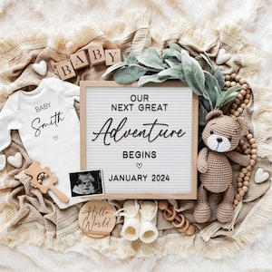Our next Great adventure, digital pregnancy Announcement, baby announcement, brown teddy bear, white letterboard, wooden bead garland, white baby booties, greenery garland, white hearts, wooden baby blocks, wooden rattle