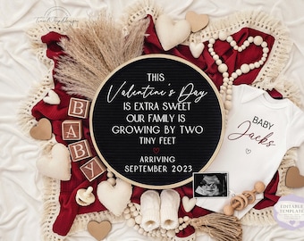 Può includere: Una lavagna nera con il testo "This Valentine's Day is extra sweet our family is growing by two tiny feet. Arriving September 2023."  Un body bianco con il testo "Baby Jacks" e una piccola immagine di ecografia sono anche inclusi nell'immagine.